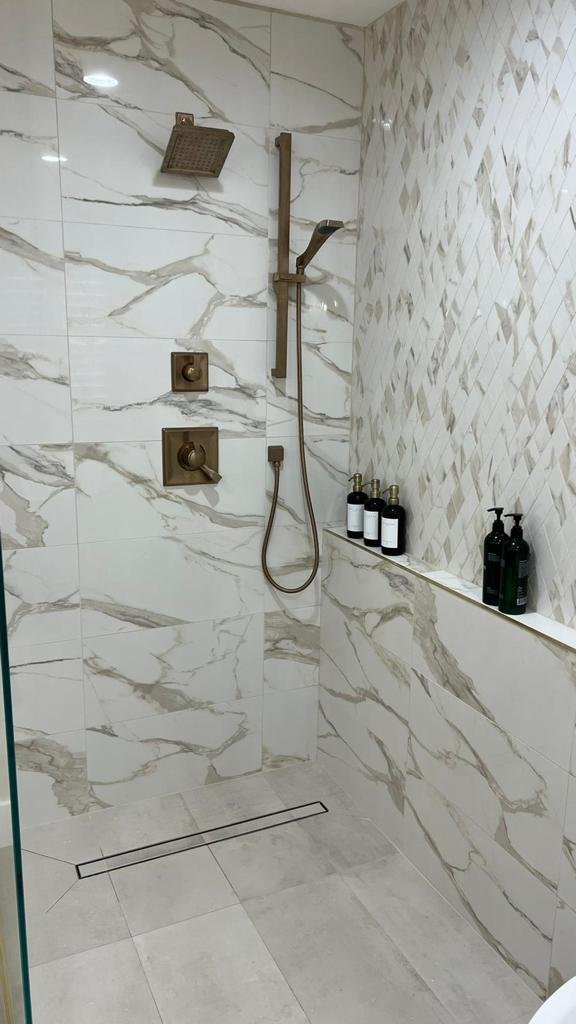Recent Acassa Construction work — walk-in marble shower with linear drain