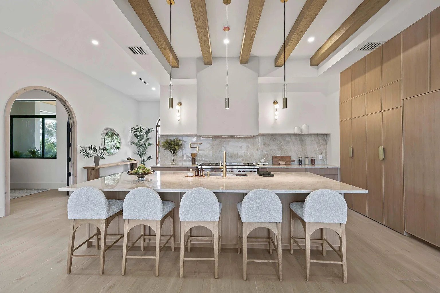 Recent Acassa Construction work — kitchen with marble waterfall island and beamed ceiling